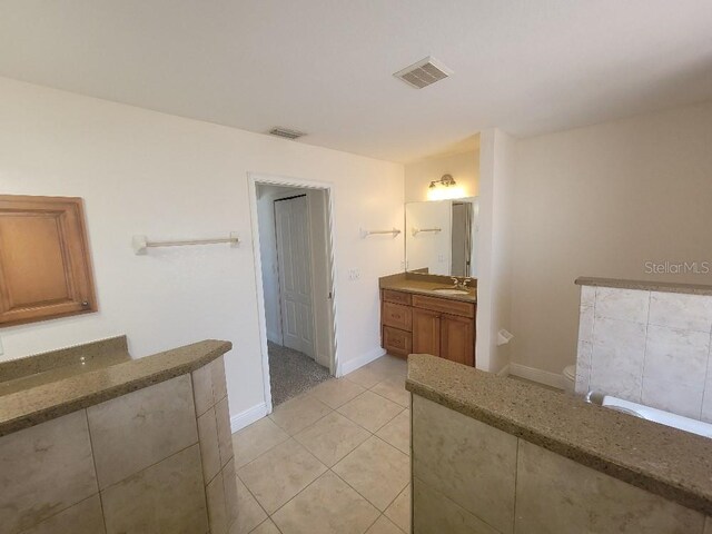 1422 Jakway Rd, North Port, FL 34288 - full bath with vanity, tile patterned floors, and baseboards