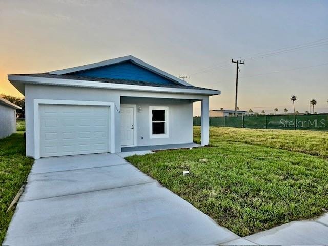 703 Salamanca Ct, Sebring, FL 33870 - ranch-style home featuring driveway, a lawn, a garage, and stucco siding