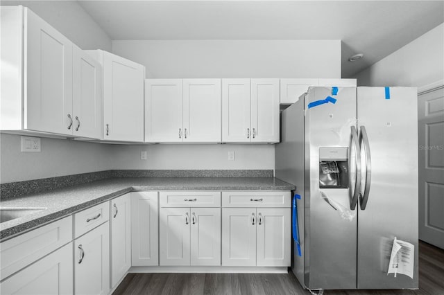 703 Salamanca Ct, Sebring, FL 33870 - kitchen with stainless steel fridge with ice dispenser, white cabinets, and dark wood finished floors