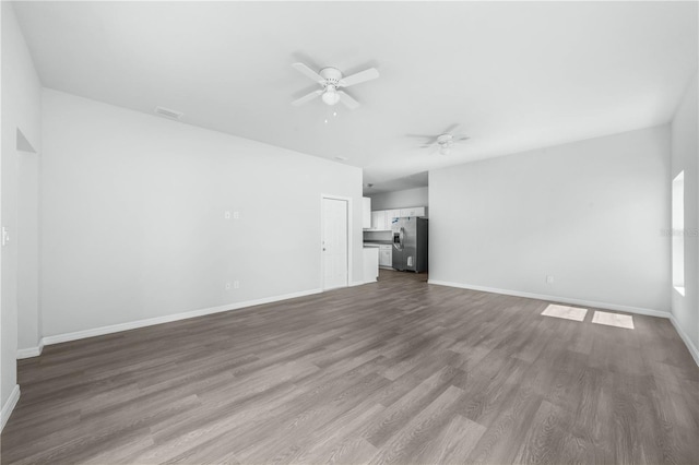 703 Salamanca Ct, Sebring, FL 33870 - unfurnished living room featuring ceiling fan, dark wood-type flooring, and baseboards