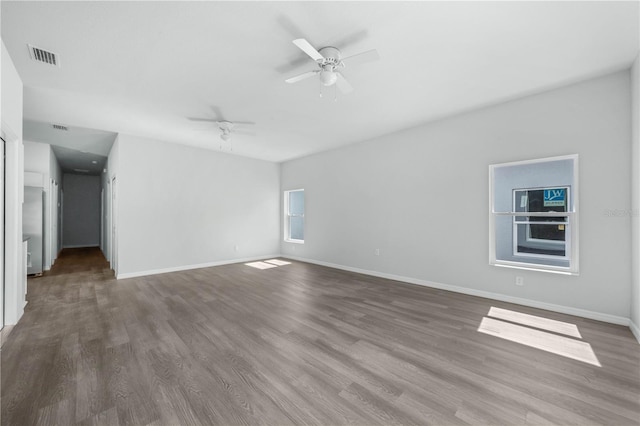 703 Salamanca Ct, Sebring, FL 33870 - empty room with wood finished floors, a ceiling fan, and baseboards
