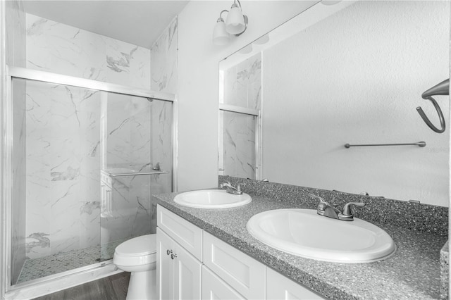 703 Salamanca Ct, Sebring, FL 33870 - bathroom with a marble finish shower, toilet, and double vanity
