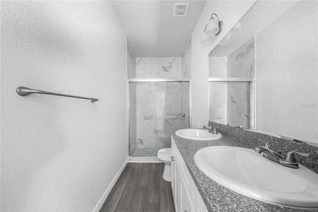 703 Salamanca Ct, Sebring, FL 33870 - bathroom with toilet, a marble finish shower, double vanity, wood finished floors, and baseboards