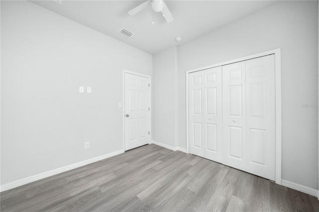 703 Salamanca Ct, Sebring, FL 33870 - unfurnished bedroom with wood finished floors, baseboards, a ceiling fan, and a closet