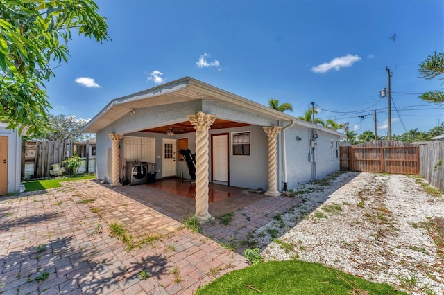 513 25th Ave W, Bradenton, FL 34205 - rear view of house with a patio, a fenced backyard, stucco siding, and washing machine and clothes dryer