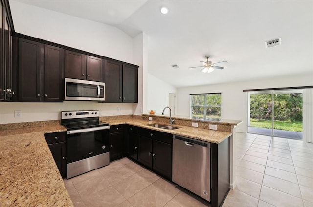 4091 Dull St, North Port, FL 34286 - kitchen with appliances with stainless steel finishes, a sink, vaulted ceiling, light tile patterned floors, and ceiling fan