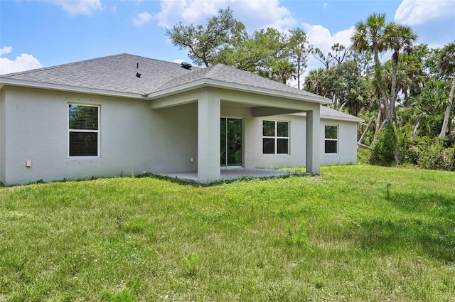 4091 Dull St, North Port, FL 34286 - rear view of property featuring a patio area, roof with shingles, stucco siding, and a yard
