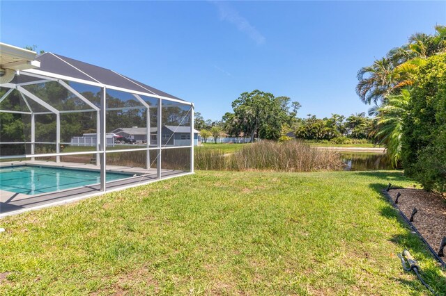 4758 Breezy Pines Blvd, Sarasota, FL 34232 - view of green lawn with an outdoor pool, a water view, and glass enclosure