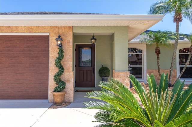 4758 Breezy Pines Blvd, Sarasota, FL 34232 - doorway to property featuring stucco siding and a garage