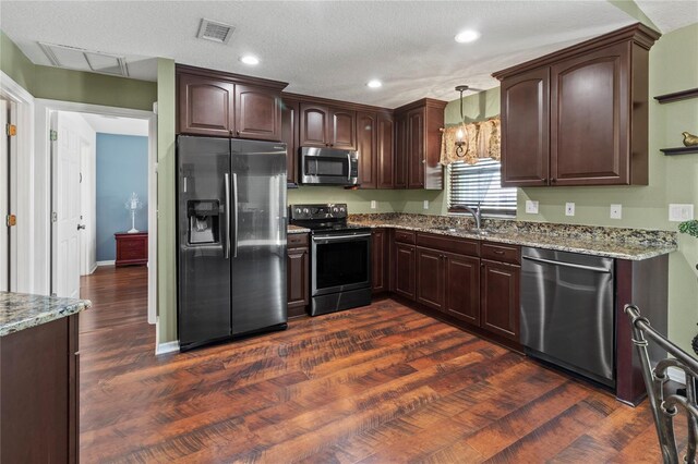4758 Breezy Pines Blvd, Sarasota, FL 34232 - kitchen featuring appliances with stainless steel finishes, a sink, dark wood-style flooring, light stone countertops, and recessed lighting