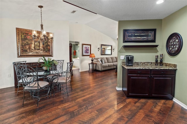 4758 Breezy Pines Blvd, Sarasota, FL 34232 - dining area featuring dark wood finished floors, lofted ceiling, baseboards, and a chandelier