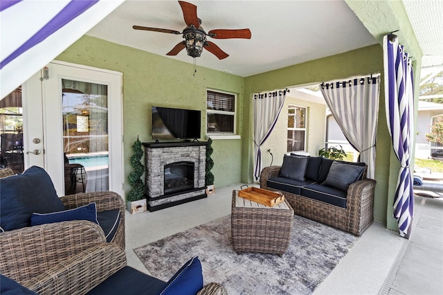 4758 Breezy Pines Blvd, Sarasota, FL 34232 - living room featuring a ceiling fan and an outdoor stone fireplace