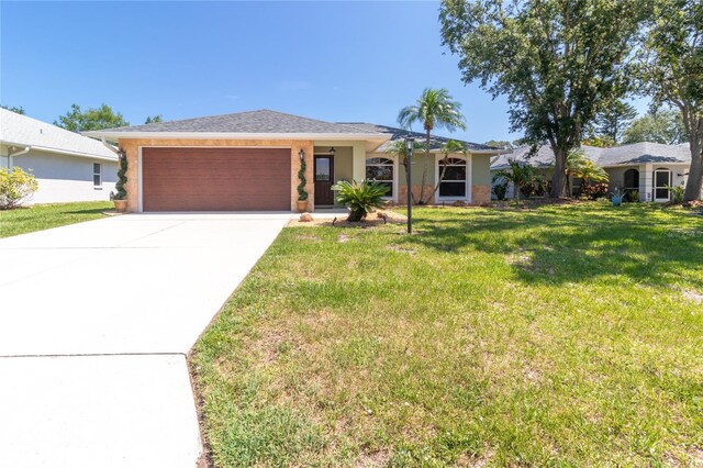 4758 Breezy Pines Blvd, Sarasota, FL 34232 - ranch-style home with an attached garage, concrete driveway, and a front yard