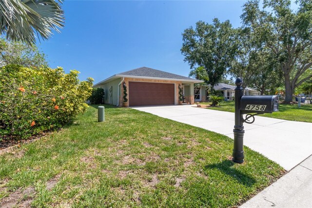 4758 Breezy Pines Blvd, Sarasota, FL 34232 - view of front of property with a front yard, concrete driveway, and an attached garage