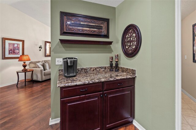 4758 Breezy Pines Blvd, Sarasota, FL 34232 - bar featuring baseboards and dark wood-type flooring