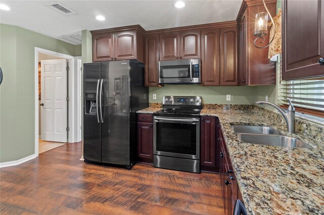 4758 Breezy Pines Blvd, Sarasota, FL 34232 - kitchen featuring stainless steel appliances, a sink, light stone counters, recessed lighting, and baseboards