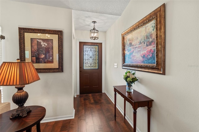 4758 Breezy Pines Blvd, Sarasota, FL 34232 - foyer featuring baseboards, dark wood-type flooring, and a chandelier
