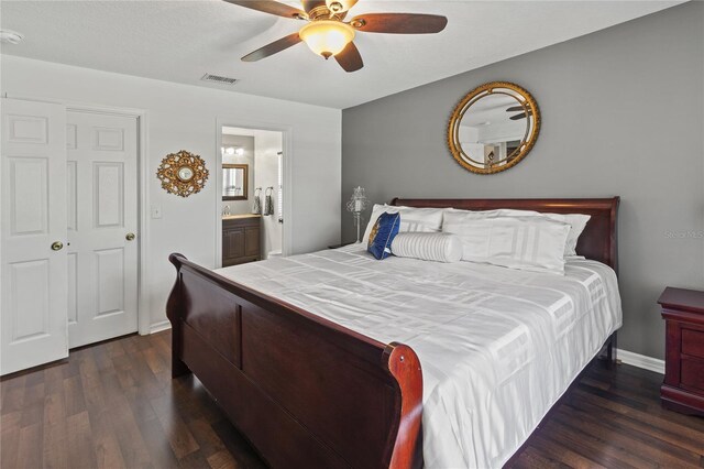 4758 Breezy Pines Blvd, Sarasota, FL 34232 - bedroom featuring dark wood-style floors, baseboards, ensuite bath, and a ceiling fan