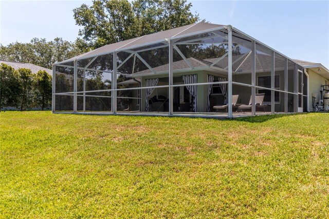 4758 Breezy Pines Blvd, Sarasota, FL 34232 - back of property featuring a lawn and glass enclosure