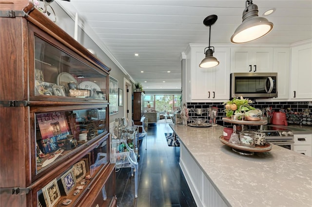 33 S Gulfstream Ave Unit 306, Sarasota, FL 34236 - kitchen with appliances with stainless steel finishes, white cabinets, recessed lighting, dark wood finished floors, and decorative light fixtures