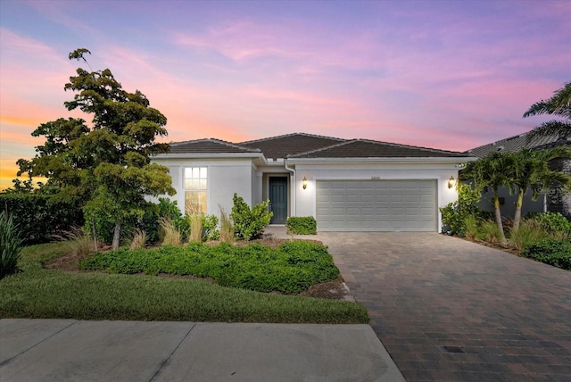 26000 Seastone Dr, Englewood, FL 34223 - single story home featuring stucco siding, driveway, a garage, and a tile roof