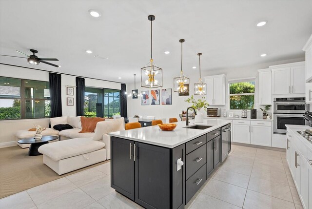 26000 Seastone Dr, Englewood, FL 34223 - kitchen featuring white cabinets, a sink, plenty of natural light, light countertops, and recessed lighting