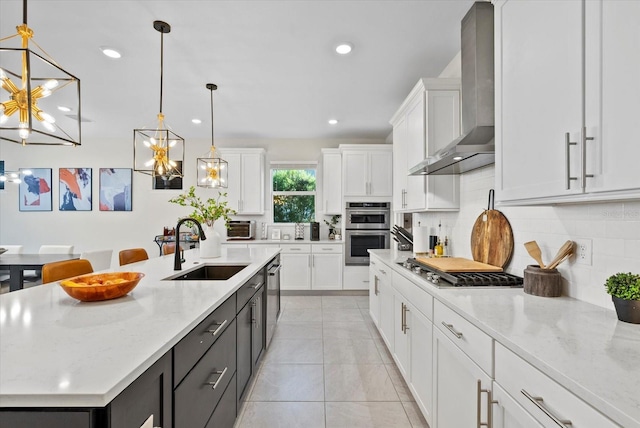 26000 Seastone Dr, Englewood, FL 34223 - kitchen with wall chimney exhaust hood, a sink, appliances with stainless steel finishes, white cabinets, and recessed lighting