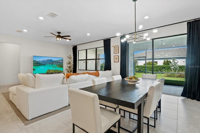 26000 Seastone Dr, Englewood, FL 34223 - dining room featuring recessed lighting, light tile patterned flooring, a chandelier, and a ceiling fan