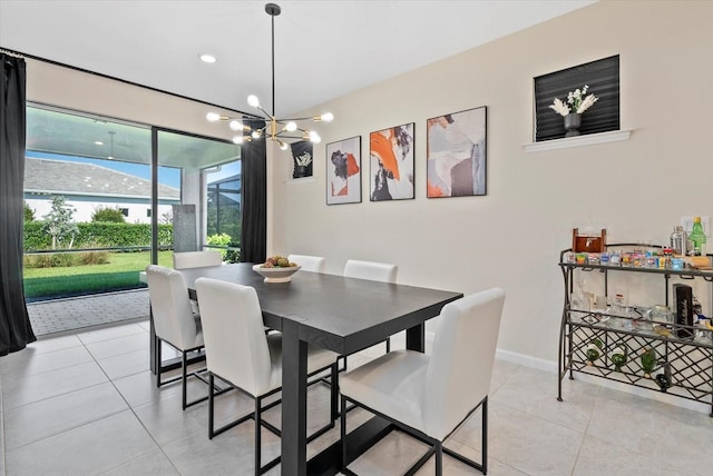 26000 Seastone Dr, Englewood, FL 34223 - dining room with light tile patterned floors, baseboards, and a chandelier