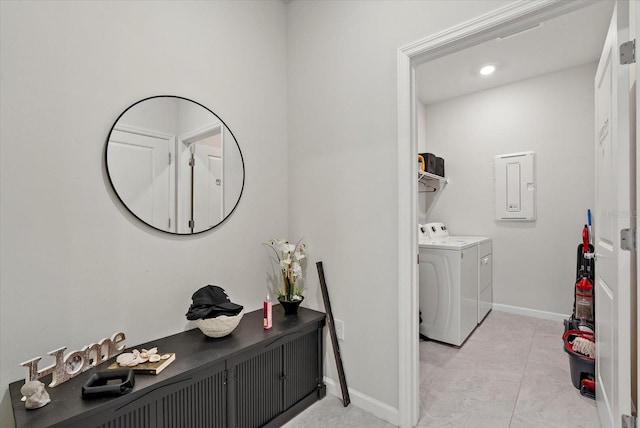 26000 Seastone Dr, Englewood, FL 34223 - laundry room featuring electric panel, washer and dryer, baseboards, and light tile patterned floors