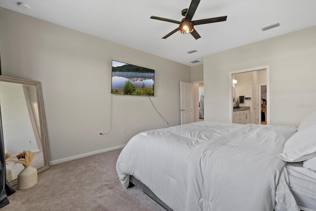 26000 Seastone Dr, Englewood, FL 34223 - bedroom with carpet flooring, baseboards, connected bathroom, and a ceiling fan