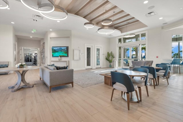 26000 Seastone Dr, Englewood, FL 34223 - dining room with french doors, wood finished floors, a high ceiling, beamed ceiling, and recessed lighting