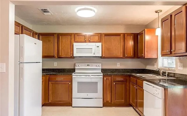 8730 Filson Pl, Sarasota, FL 34231 - kitchen featuring white appliances, brown cabinets, a sink, and pendant lighting