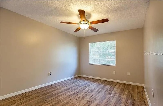 8730 Filson Pl, Sarasota, FL 34231 - empty room featuring wood finished floors, a textured ceiling, a ceiling fan, and baseboards