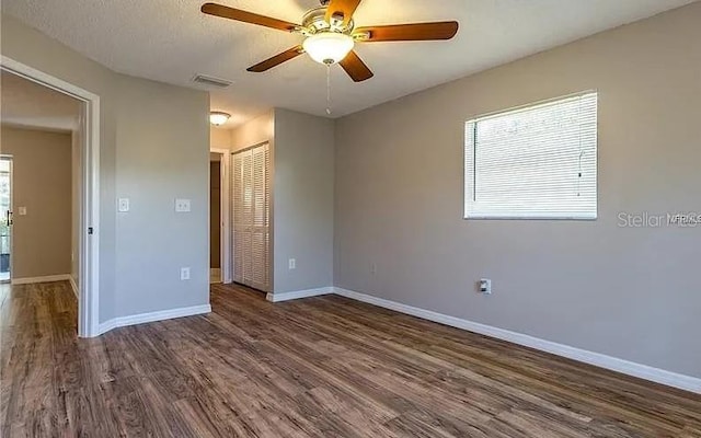 8730 Filson Pl, Sarasota, FL 34231 - unfurnished bedroom featuring a closet, wood finished floors, baseboards, and ceiling fan
