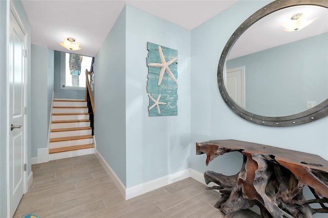 1001 Point Of Rocks Rd Unit 207, Sarasota, FL 34242 - hall with light wood-type flooring, baseboards, and stairs