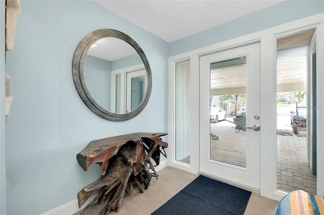 1001 Point Of Rocks Rd Unit 207, Sarasota, FL 34242 - doorway featuring baseboards and light wood-type flooring