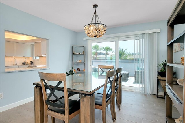 1001 Point Of Rocks Rd Unit 207, Sarasota, FL 34242 - dining area with a chandelier and light wood-style flooring