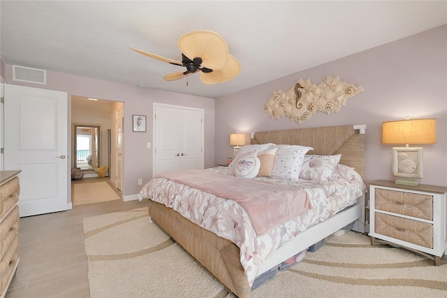 1001 Point Of Rocks Rd Unit 207, Sarasota, FL 34242 - bedroom featuring a ceiling fan, a closet, baseboards, and wood finished floors