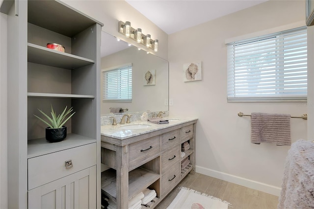 1001 Point Of Rocks Rd Unit 207, Sarasota, FL 34242 - full bathroom featuring double vanity, wood finished floors, and baseboards