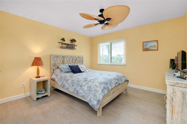 1001 Point Of Rocks Rd Unit 207, Sarasota, FL 34242 - bedroom featuring baseboards, light wood-style floors, and a ceiling fan