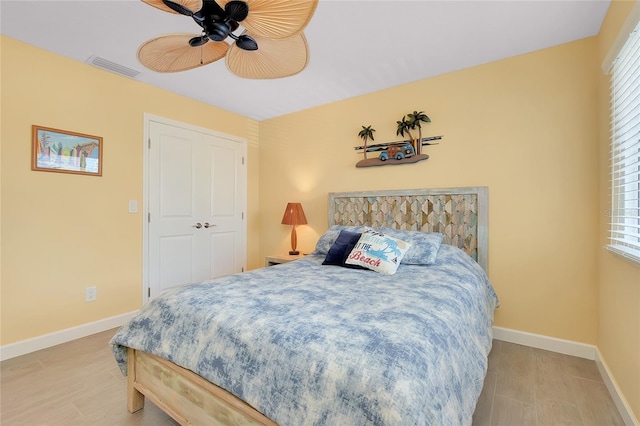 1001 Point Of Rocks Rd Unit 207, Sarasota, FL 34242 - bedroom featuring multiple windows, baseboards, ceiling fan, and light wood-style flooring