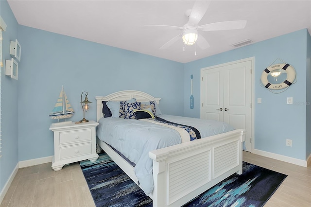 1001 Point Of Rocks Rd Unit 207, Sarasota, FL 34242 - bedroom with baseboards, a ceiling fan, wood finished floors, and a closet