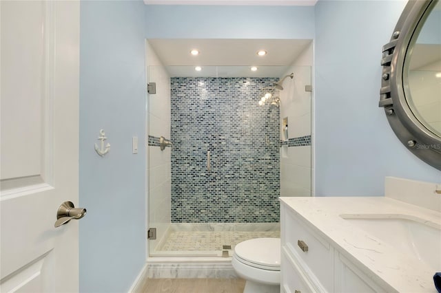 1001 Point Of Rocks Rd Unit 207, Sarasota, FL 34242 - bathroom with a stall shower, toilet, vanity, and recessed lighting