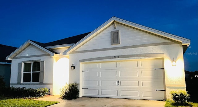 2410 Mizner Bay Ave, Bradenton, FL 34208 - view of front of property with concrete driveway, stucco siding, and an attached garage