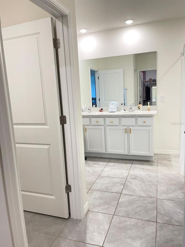 2410 Mizner Bay Ave, Bradenton, FL 34208 - bathroom with double vanity, tile patterned flooring, recessed lighting, and a walk in closet