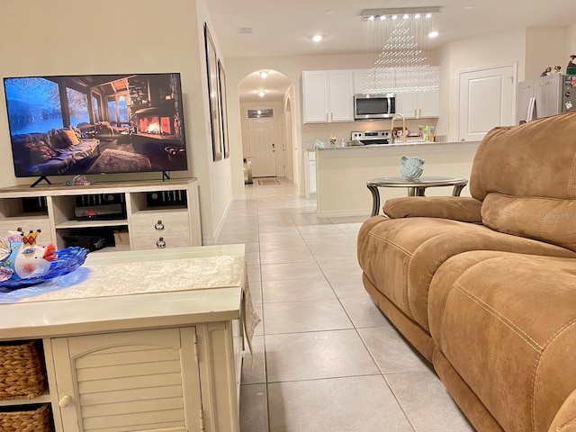 2410 Mizner Bay Ave, Bradenton, FL 34208 - living area with light tile patterned flooring, arched walkways, baseboards, and recessed lighting
