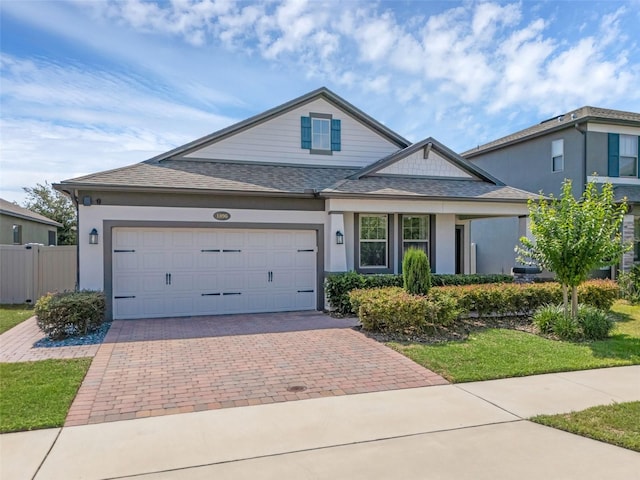 1896 Napoli Dr, Saint Cloud, FL 34771 - traditional-style house with decorative driveway, a shingled roof, stucco siding, and a garage