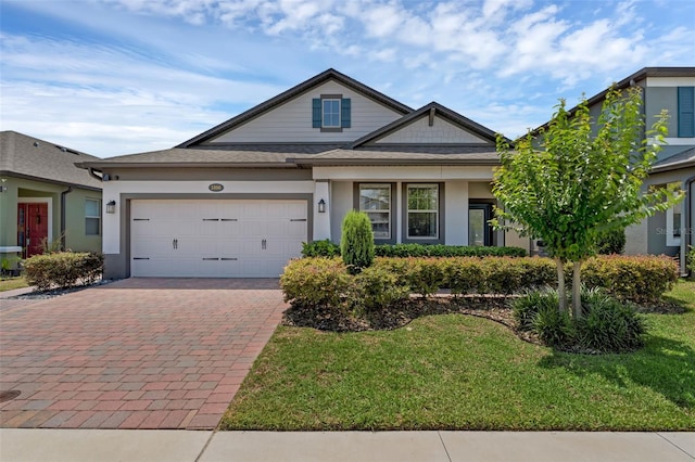1896 Napoli Dr, Saint Cloud, FL 34771 - view of front of house with decorative driveway, an attached garage, a front lawn, and stucco siding