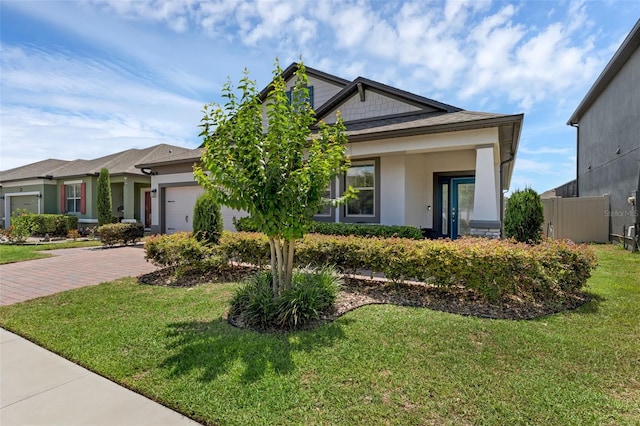 1896 Napoli Dr, Saint Cloud, FL 34771 - view of front facade with a garage, stucco siding, decorative driveway, and a front yard